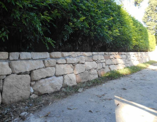 Hand Placed Sandstone Rock Wall Installation in Carrara