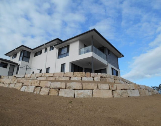 Creating Usable Garden Space with Sandstone Boulder Walls in Reedy Creek