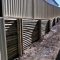 Treated Pine log wall & Colorbond fence - Southport, Gold Coast - Australian Retaining Walls 1